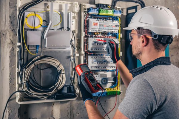 man-electrical-technician-working-switchboard-with-fuses